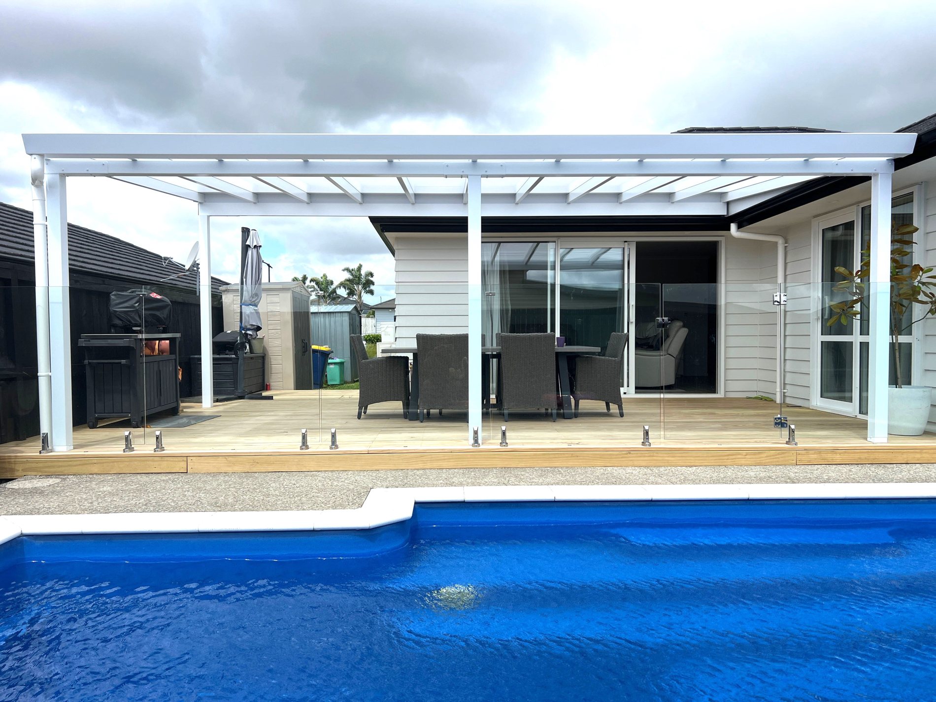 Pergola beside a pool at dusk