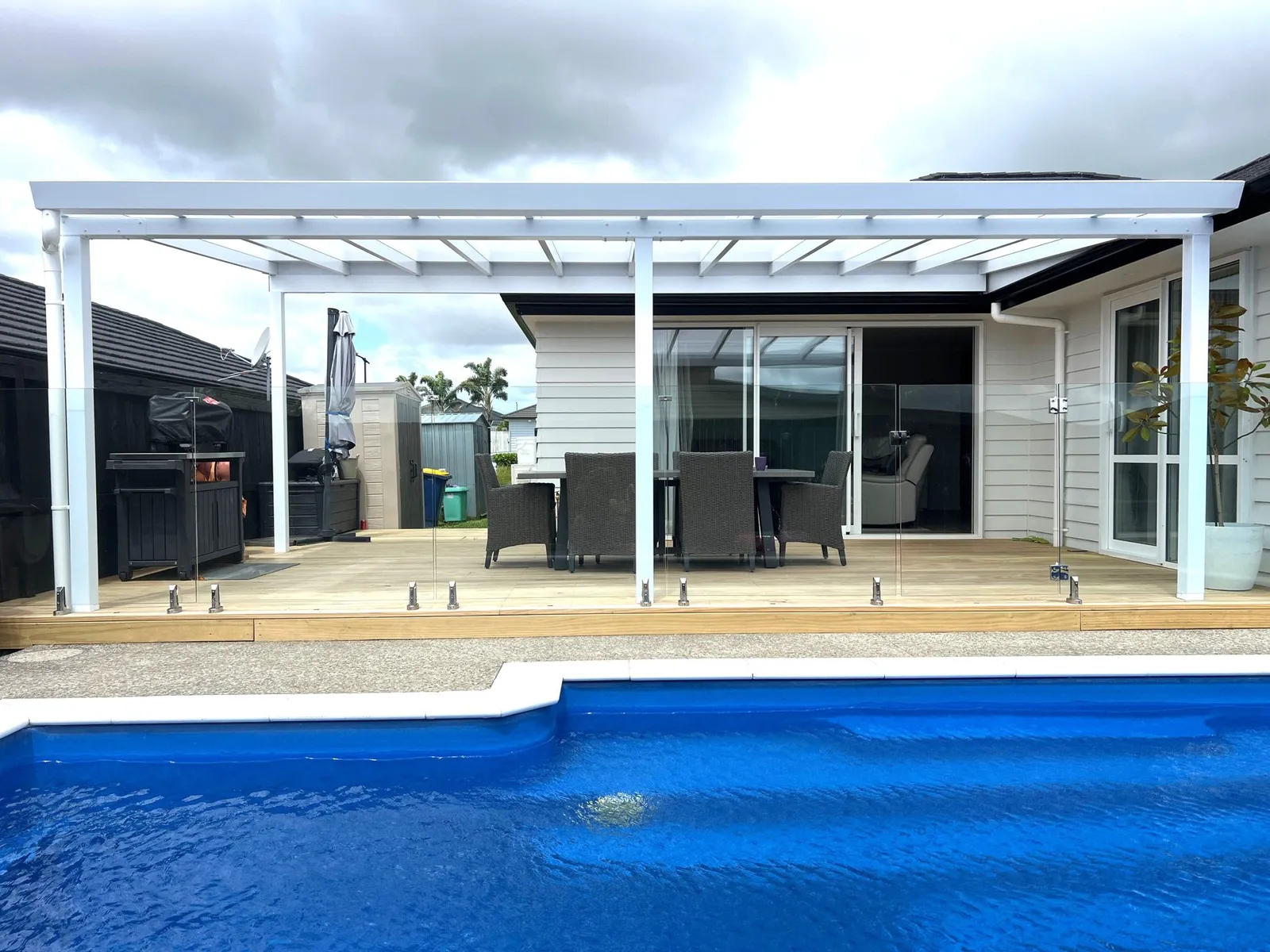 Pergola beside a pool at dusk