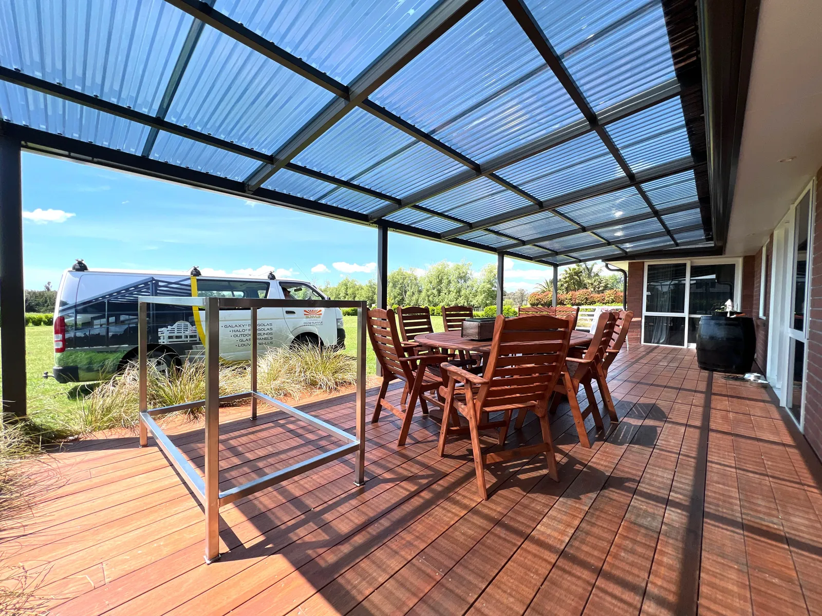 Clean timber deck under a SUNVUE aluminium pergola roof