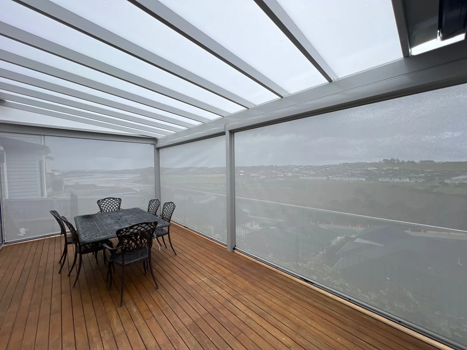 Timber deck under a pergola with a coastal outlook
